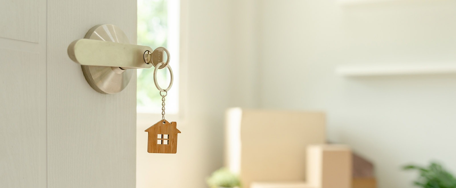 House key inserted in lock symbolizing unlocking a new home with a mortgage.