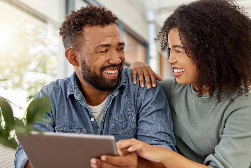 Couple reviewing options to save money by refinancing their auto loan