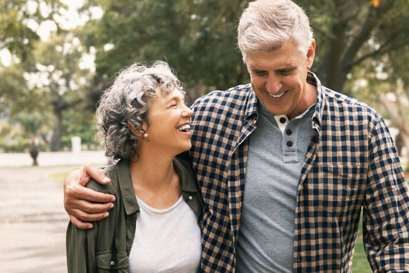 mature couple hugging and walking outside