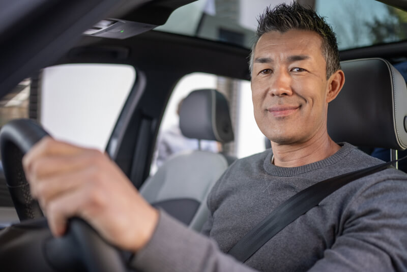 smiling mature man in car