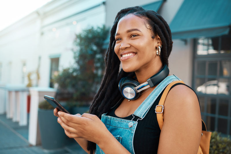 Young woman manages digital banking on smartphone.